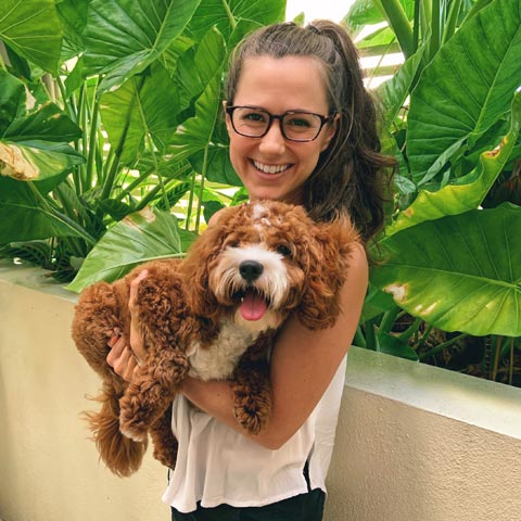 Emily holding a cute puppy during her recent phone detox